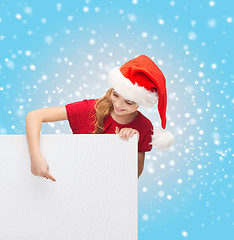 Image showing woman in santa helper hat with blank white board