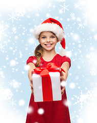 Image showing smiling girl in santa helper hat with gift box