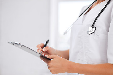 Image showing female doctor with stethoscope and prescription