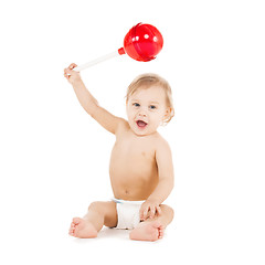Image showing cute little boy playing with big lollipop