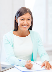 Image showing asian businesswoman with laptop and documents