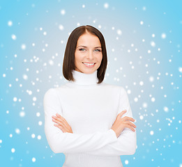 Image showing smiling woman in white sweater