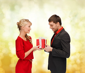 Image showing smiling woman and man with gift box