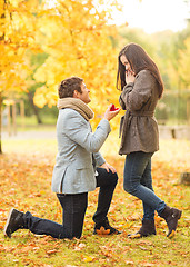 Image showing man proposing to a woman in the autumn park