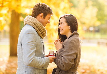 Image showing man proposing to a woman in the autumn park