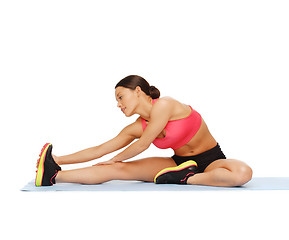 Image showing sporty woman doing exercise on the floor