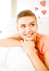 Image showing happy woman in love dreaming at home