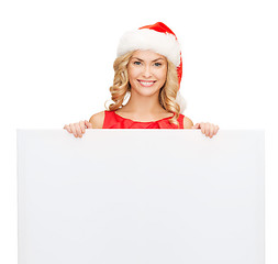 Image showing woman in santa helper hat with blank white board