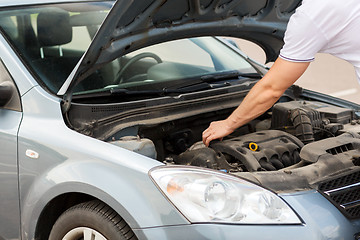 Image showing man opening car bonnet