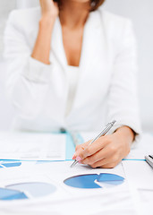 Image showing woman with documents taking phone call