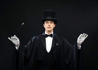 Image showing magician in top hat with magic wand showing trick