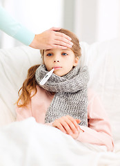 Image showing ill girl child with thermometer and caring mother