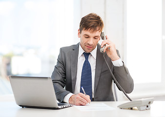 Image showing businessman with laptop computer and phone