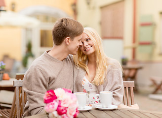 Image showing romantic happy couple kissing in the cafe