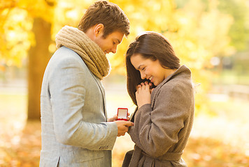 Image showing man proposing to a woman in the autumn park