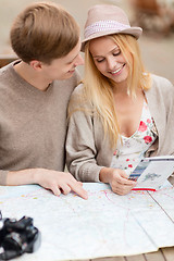 Image showing couple with map, camera and travellers guide