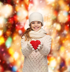 Image showing girl in winter clothes with small red heart