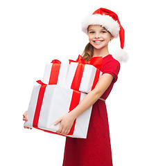 Image showing girl in santa helper hat with many gift boxes