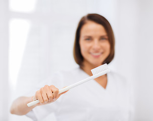 Image showing dentist with toothbrush in hospital