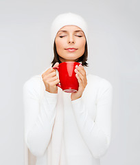 Image showing woman in hat with red tea or coffee mug