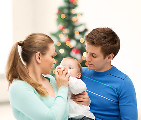 Image showing family and adorable baby with feeding-bottle