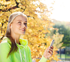 Image showing woman listening to music outdoors