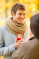 Image showing man proposing to a woman in the autumn park