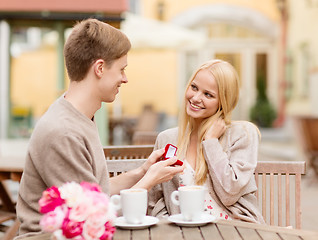 Image showing romantic man proposing to beautiful woman