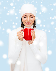 Image showing woman in hat with red tea or coffee mug