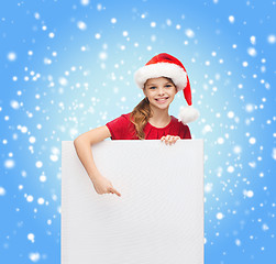 Image showing woman in santa helper hat with blank white board