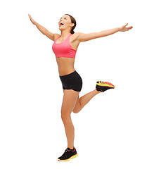 Image showing beautiful sporty woman running or jumping