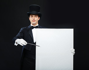 Image showing magician in top hat with magic wand showing trick