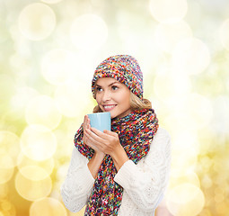 Image showing woman in hat with red tea or coffee mug