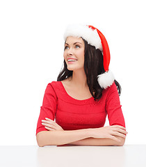 Image showing surprised woman in santa helper hat looking up