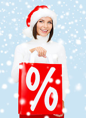 Image showing woman in santa helper hat with shopping bags