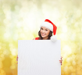 Image showing woman in santa helper hat with blank white board