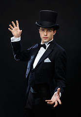 Image showing magician in top hat showing trick