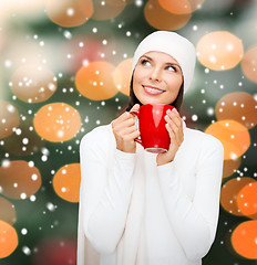 Image showing woman in hat with red tea or coffee mug