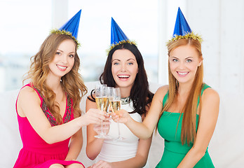 Image showing three women wearing hats with champagne glasses