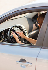 Image showing woman using phone while driving the car