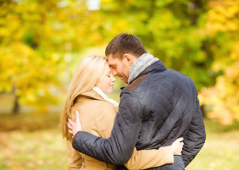 Image showing romantic couple kissing in the autumn park