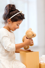 Image showing happy child girl with gift box and teddy bear