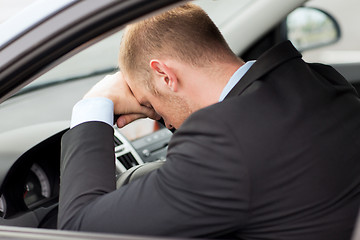 Image showing tired businessman or taxi car driver