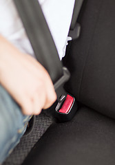 Image showing man fastening seat belt in car