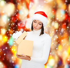 Image showing suspicious woman in santa helper hat with gift box