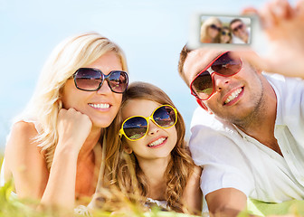 Image showing happy family with camera taking picture