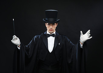 Image showing magician in top hat with magic wand showing trick