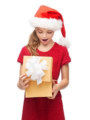 Image showing smiling girl in santa helper hat with gift box