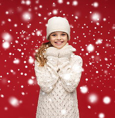 Image showing smiling girl in white hat, muffler and gloves