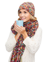 Image showing woman in hat with red tea or coffee mug